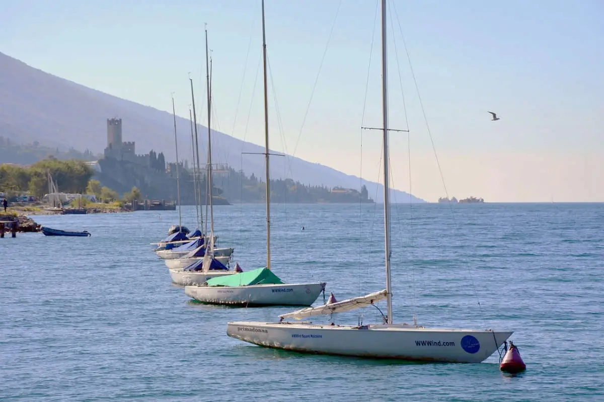 Soling an der Boje vor Wassersportcenter am Gardasee in Malcesine